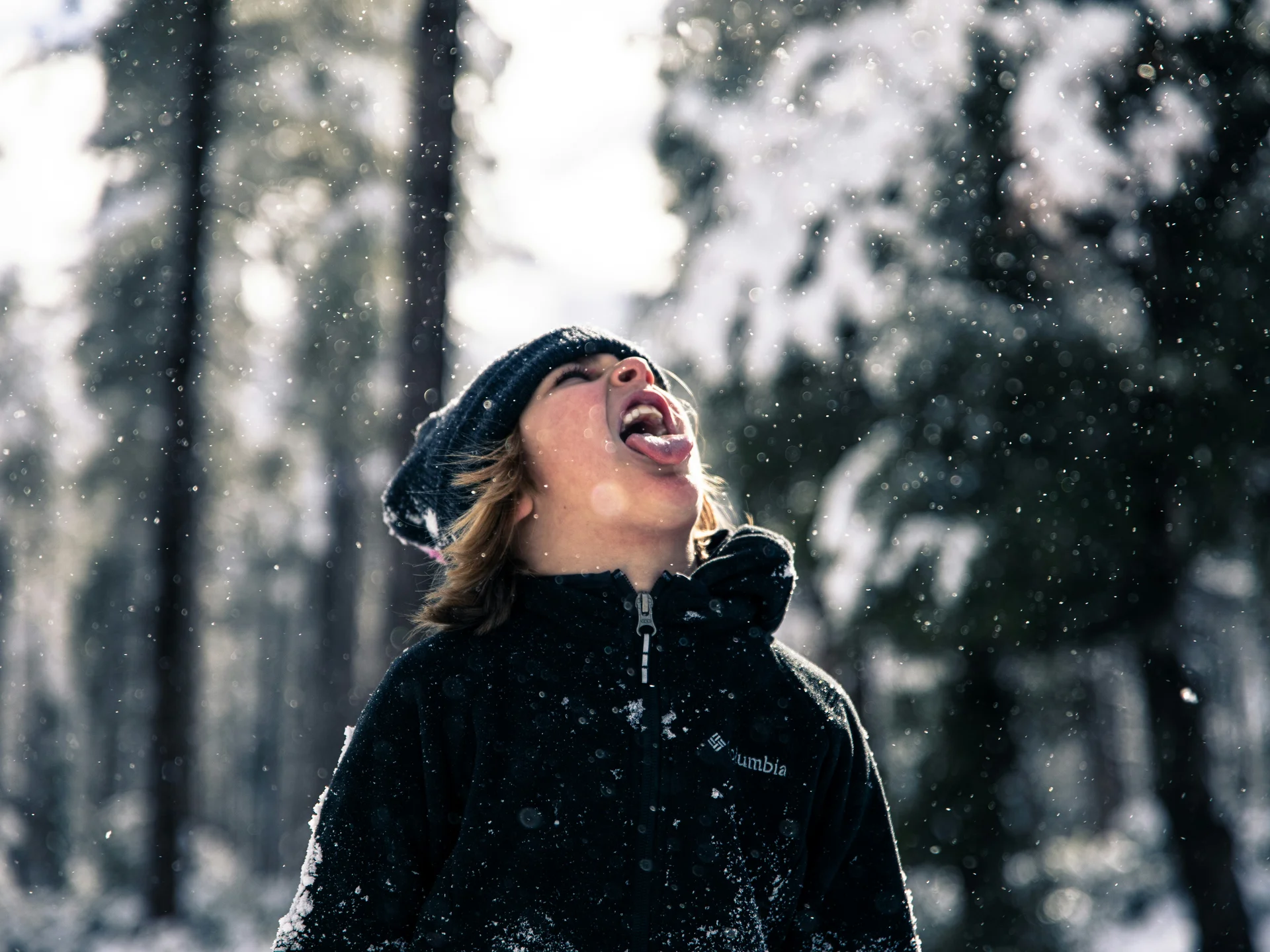 Pictures from Hotel Salnerhof Child catching snowflakes with tongue in snowy forest