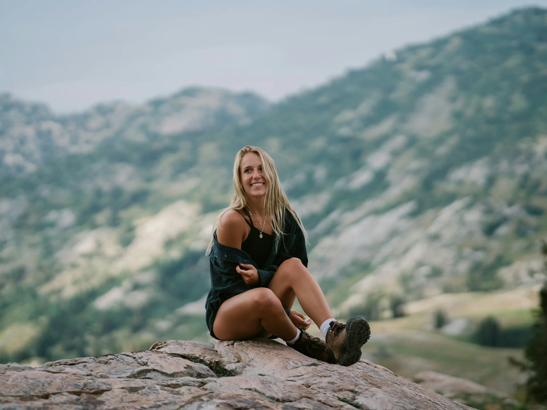 Pictures from Hotel Salnerhof Woman sitting on rock with mountain landscape in the background
