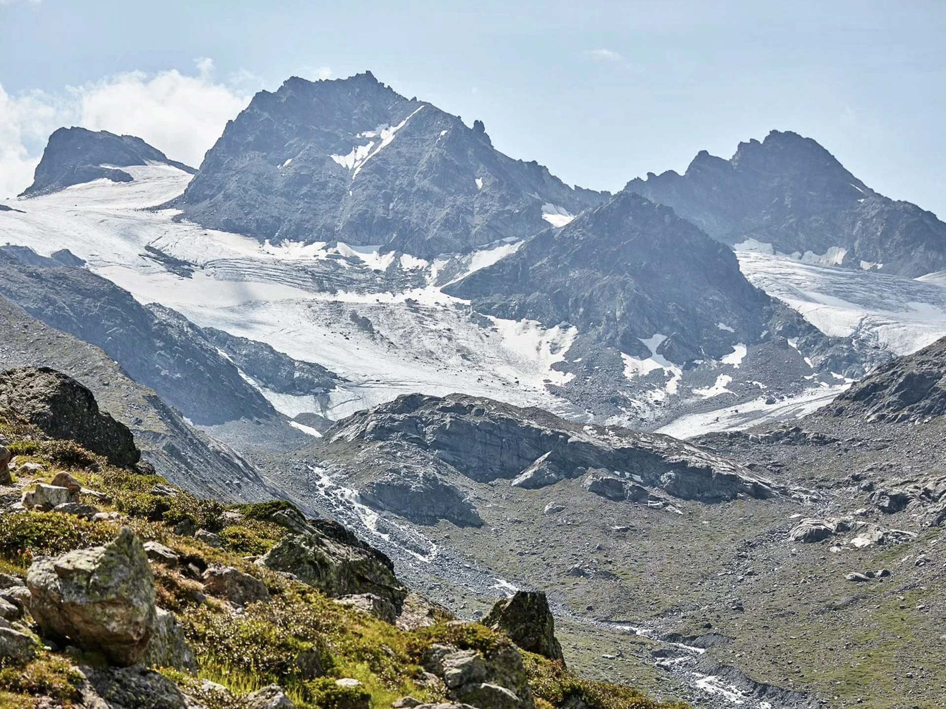 Pictures from Hotel Salnerhof Mountain landscape with snow-covered peaks and rocky valley in sunlight