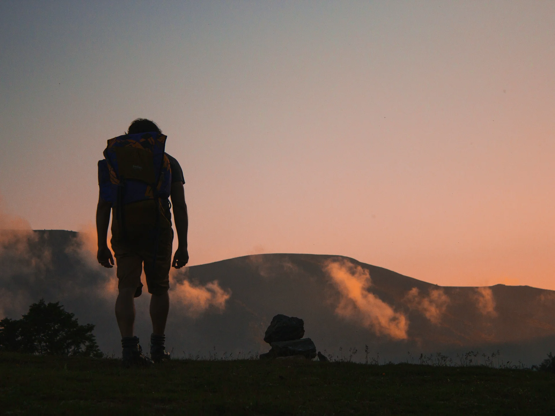 Pictures from Hotel Salnerhof Hiker with backpack in front of mountain landscape at sunset